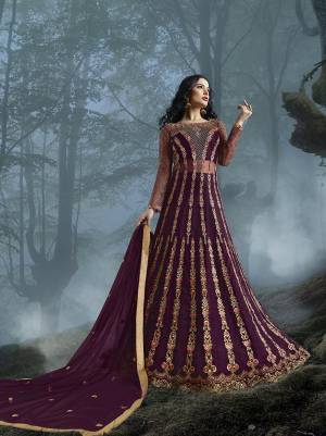Grab This Heavy Designer Floor Length Suit In Wine Color For The Upcoming Wedding Season. This Very Beautiful And Heavy Embroidered Floor Length Top Is Fabricated On Net Paired With Silk based Bottom And Net Fabricated Dupatta. Its Detailed Embroidery With Perfect Color Combination Will Earn You Lots Of Compliments From Onlookers.
