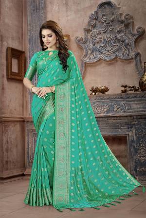 Celebrate This Festive Season In This Attractive Green Colored Saree. This Saree And Blouse Are Fabricated On Art Silk Beautified With Weaving And Stone Work. This Silk Based Saree Gives A Rich Look To Your Personality. 