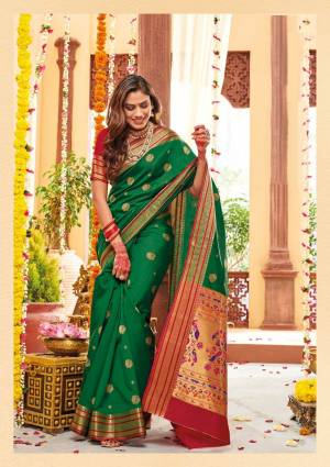 Flaunt Your Rich And Elegant Taste Wearing This Lovely Silk Based Saree In Green Color Paired With Contrasting Red Colored Blouse. This Saree And Blouse Are Fabricated On Banarasi Art Silk Beautified With Weave. Buy Now.