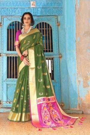 Flaunt Your Rich And Elegant Taste Wearing This Lovely Silk Based Saree In Olive Green Color Paired With Contrasting Pink Colored Blouse. This Saree And Blouse Are Fabricated On Cotton Silk Beautified With Weave. Buy Now.