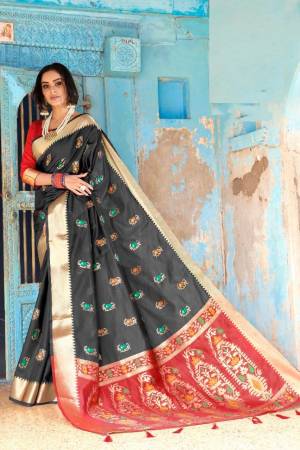 Shine Bright Wearing This Attractive Looking Saree In Black Color Paired With Contrasting Red Colored Blouse. This Saree And Blouse Are Fabricated On Cottot Silk Beautified With Weave. Buy This Saree Now.