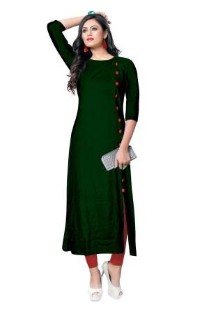 For Your Casual Wear, Grab This Simple And Elegant Looking Readymade Kurti In Dark Green Color Fabricated On Rayon. It Is Beautified With Contrasting Buttons With A Front Side Slit. Its Fabric Is Soft Towards Skin And Available In All Regular Sizes. Buy This Pretty Kurti Now.