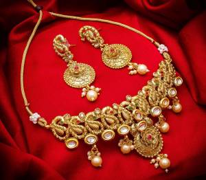 Give An Enhanced Look To Your Personality By Pairing Up This Beautiful Necklace Set With Your Ethnic Attire. This Pretty Set Is In Golden Color Beautified With Stone And Pearl Work. Buy Now