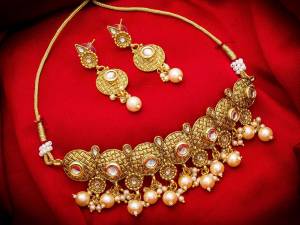 Give An Enhanced Look To Your Personality By Pairing Up This Beautiful Necklace Set With Your Ethnic Attire. This Pretty Set Is In Golden Color Beautified With Stone And Pearl Work. Buy Now
