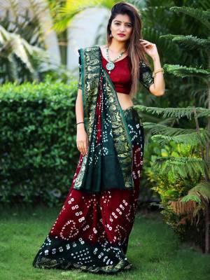 Here Is A Beautiful Bandhej Designer Saree In Maroon And Pine Green Color. This Saree And Blouse Are Fabricated On Art Silk Which Also Gives A Rich Look To Your Personality. Buy Now.