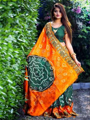 Here Is A Beautiful Bandhej Designer Saree In Teal Green And Orange Color. This Saree And Blouse Are Fabricated On Art Silk Which Also Gives A Rich Look To Your Personality. Buy Now.