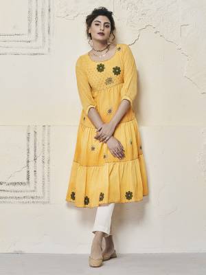 Get Ready For The Upcoming Festive Season With This Designer Readymade Kurti In Yellow Color. This A-Line Patterned Kurti Is Fabricated on Cotton Slub Beautified With Contrasting Thread Work. 