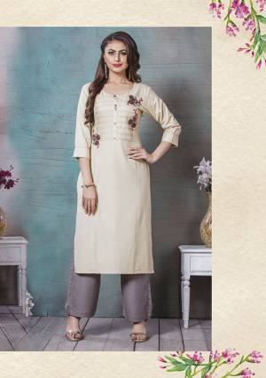 Here Is A Lovely Readymade Kurti To Add Into Your Wardrobe In Cream Color. This Kurti Is Rayon Cotton Based Beautified With Prints And Thread Work. Buy Now.