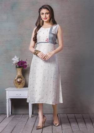 Here Is A Lovely Readymade Kurti To Add Into Your Wardrobe In Off-White Color. This Kurti Is Art Silk Based Beautified With Prints And Thread Work. Buy Now.