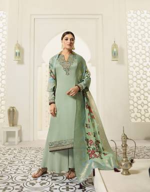 You Will Definitely Earn Lots Of Compliments Wearing This Designer Straight Suit In Pastel Green Color. Its Embroidered Top Is Fabricated On Satin Georgette Paired With Santoon Bottom And Jacquard Silk Dupatta. Its Rich Color And Fabric Will Give You A Look Like Never Before. 