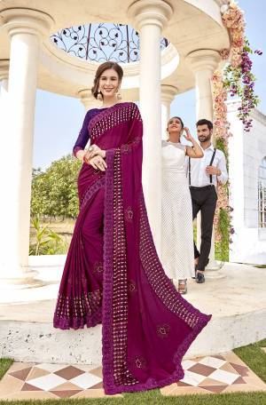 Catch All The Limelight Wearing This Heavy Designer Saree In Magenta Pink Color Paired With Purple Colored Blouse. This Saree Is Fabricated On Georgette And Brasso Paired With art Silk Fabricated Blouse. 
