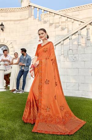 Shine Bright In This Designer Orange Colored Saree Paired With Orange Colored Blouse. This Saree Is Fabricated On Soft Silk And Brasso Paired With Art Silk Fabricated Blouse. It Is Beautified With Embroidery And Highlighted With Brasso Fabric.