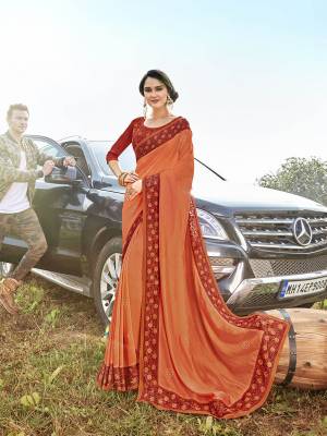 Attract All Wearing This Designer Saree In Orange Color Paired With Contrasting Red Colored Blouse. This Saree Is Fabricated On Satin Georgette Paired With Art Silk Fabricated Blouse. It Is Beautified With Embroidered Lace Border And Blouse.  