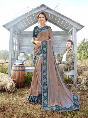 Attract All Wearing This Designer Saree In Rose Gold Color Paired With Contrasting Teal Blue Colored Blouse. This Saree Is Fabricated On Satin Georgette Paired With Art Silk Fabricated Blouse. It Is Beautified With Embroidered Lace Border And Blouse.  