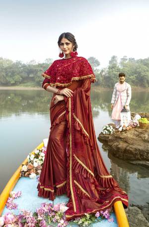 For A Royal Look, Grab This Designer Fancy Saree With Cape In Red Color. This Pretty Saree Is Fabricated On Lycra Paired With Art Silk Fabricated Blouse And Embroidered Net Fabricated Cape. Its Trendy Pattern And Design Will Earn You Lots Of Compliments From Onlookers.