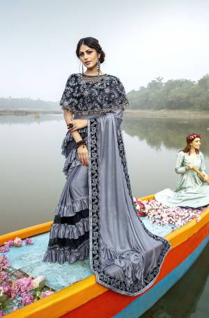 Grab This Very Beautiful Trendy Saree In Grey And Black Color. This Saree Is Fabricated On Lycra Paired With Art Silk Blouse And Net Fabricated Heavy Embroidered Cape. Its Fabric Is Light Weight And Ensures Superb Comfort Throughout The Gala.