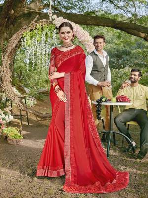Adorn The Pretty Angelic Look Wearing This Designer Saree In Red Color Paired With Red Colored Blouse. This Saree Is Georgette Based Paired With Art Silk And Net Fabricated Blouse. It Is Beautified With Heavy Embroidered Blouse And Saree Lace Border. 