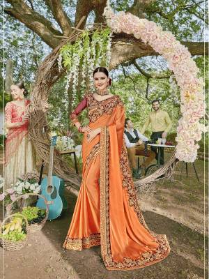 Celebrate This Festive Season In A Traditional Look Wearing This Heavy Designer Saree In Orange Color Paired With Maroon Colored Blouse. This Saree Is Fabricated On Satin Georgette Paired With Art Silk And Net Fabricated Blouse. Buy This Lovely Saree Now.