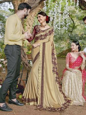 For A Royal Elegant Look, Grab This Designer Saree In Cream Color Paired With Contrasting Maroon Colored Blouse. This Saree Is Fabricated On Satin Georgette Paired With Art Silk And Net Fabricated Blouse. Its Rich Color Pallete And Fabric Will Definitely Earn You Lots Of Compliments From Onlookers.