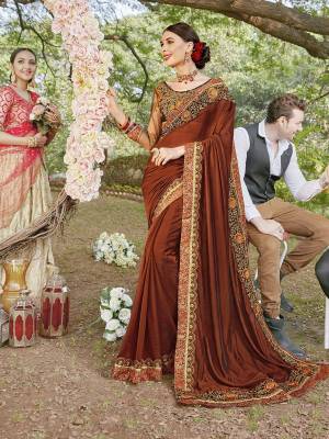 Go With The Lovely Shades Of Brown Wearing This Heavy Designer Saree In Brown Color Paired With Dark Brown Colored Blouse. This Saree Is Satin Georgette Based Paired With Art Silk And Net Fabricated Blouse. 