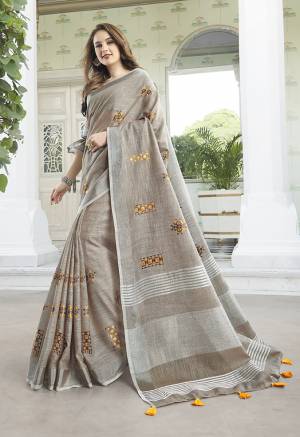 Flaunt Your Rich And Elegant Taste Wearing This Lovely Sand Grey Colored Designer Saree. This Saree And Blouse Are Fabricated On Linen Cotton Which Gives A Rich Look To Your Personality. It Is Beautified With Embroidered Butti All Over The Saree. 