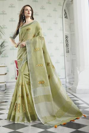 Flaunt Your Rich And Elegant Taste Wearing This Lovely Light Green Colored Designer Saree. This Saree And Blouse Are Fabricated On Linen Cotton Which Gives A Rich Look To Your Personality. It Is Beautified With Embroidered Butti All Over The Saree. 