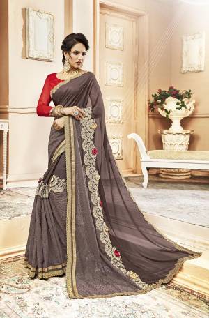 Here Is A Beautiful Designer Saree In Grey Color Paired With Contrasting Red Colored Blouse. This Saree Is Fabricated On Shimmer Georgette Paired With Art Silk Fabricated Blouse. Its Designer Pattern Will Give You Look Like Never Before. 