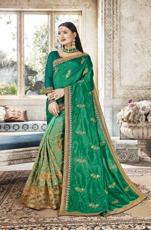 Celebrate This Festive Season In This Lovely Green Colored Saree. This Saree Is Fabricated On Art Silk And Georgette Paired With Art Silk Fabricated Blouse. Buy This Saree Now.