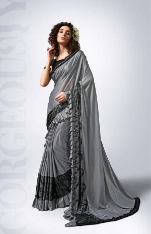 For A Bold And Beautiful Look, Grab This Designer Lycra Based Saree?In Grey Color Paired With Black Colored Blouse. This Saree Is Beautified With Frill And Fancy Lace Border. It Is Light Weight And Durable. Buy Now.