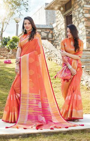 Look Pretty In This Elegant And Rich Looking Saree In Orange Color Paired With Orange Colored Blouse. This Saree And Blouse Are Fabricated On Linen Cotton Beautified With Weave. This Saree Is Light Weight, Durable And Easy To Carry All Day Long. 