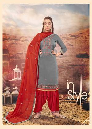 Add This Beautiful Designer Patiala Suit To Your Wardrobe In Grey Colored Top Paired With Contrasting Red Colored Bottom And Dupatta. Its Top Is Cotton Silk Based Paired With Rayon Bottom And Chiffon Fabricated Dupatta. Buy Now. 