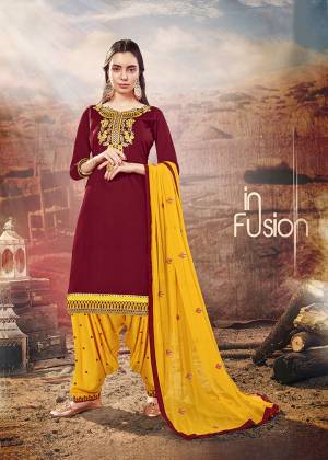 Add This Beautiful Designer Patiala Suit To Your Wardrobe In Maroon Colored Top Paired With Contrasting Yellow Colored Bottom And Dupatta. Its Top Is Cotton Silk Based Paired With Rayon Bottom And Chiffon Fabricated Dupatta. Buy Now. 