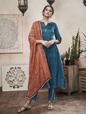Another Beautiful A-Line Patterned Readymade Suit Is Here In Blue Color Paired with Rust Orange Colored Dupatta. Its Top And Dupatta are Fabricated On Muslin Paired With Satin Fabricated Bottom. Buy This Suit Now.