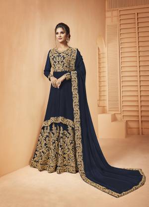 Add This Lovely Designer Floor Length Suit To Your Wardrobe In Navy Blue Color. Its Heavy Embroidered Top and Dupatta Are Fabricated on Georgette Paired With Santoon Fabricated Bottom. It Is Beautified With Detailed Coding Embroidery Giving You An Attractive Look. 