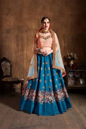 Add This Very Pretty Designer Lehenga Choli To Your Wardrobe In Peach Colored Blouse Paired With Contrasting Blue Colored Lehenga And Peach Colored Dupatta. Its Pretty Blouse And Lehenga Are Fabricated On Art Silk Paired With Net Fabricated Dupatta. Buy Now. 