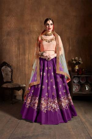 Add This Very Pretty Designer Lehenga Choli To Your Wardrobe In Peach Colored Blouse Paired With Contrasting Purple Colored Lehenga And Peach Colored Dupatta. Its Pretty Blouse And Lehenga Are Fabricated On Art Silk Paired With Net Fabricated Dupatta. Buy Now. 