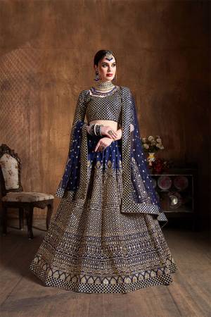 You Will Definitely Earn Lots Of Compliments Wearing This Heavy Designer Lehenga Choli In Navy Blue Color. This Pretty Designer Embroidered Lehenga Choli Is Fabricated On Art Silk Paired With Net Fabricated Dupatta. Buy This Lehenga Choli Now.