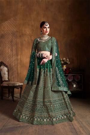 You Will Definitely Earn Lots Of Compliments Wearing This Heavy Designer Lehenga Choli In Dark Green Color. This Pretty Designer Embroidered Lehenga Choli Is Fabricated On Art Silk Paired With Net Fabricated Dupatta. Buy This Lehenga Choli Now.