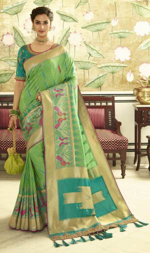 For A Proper Traditional Look, Grab This Designer Saree In Light Green Color Paired With Contrasting Turquoise Blue colored Blouse. This Heavy Weaved Saree Is Banarasi Art Silk Based Paired With Art Silk Fabricated Heavy Embroidered Blouse. Buy This Saree Now.