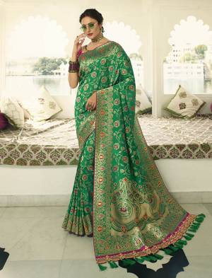 Celebrate This Festive Season In A Lovely Traditional Look With This Heavy Designer Saree In Green Color Paired With Rani Pink Colored Blouse. This Saree Is Fabricated on Banarasi Art Silk Beautified With Heavy Weave Paired with Art Silk Fabricated Blouse Beautified With heavy Embroidery.