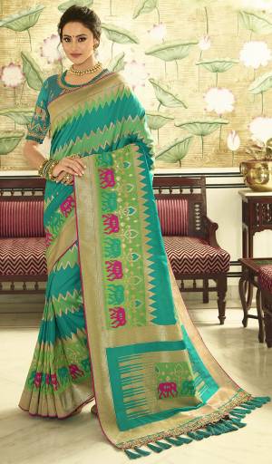 For A Proper Traditional Look, Grab This Designer Saree In Blue And Green Color Paired With Green colored Blouse. This Heavy Weaved Saree Is Banarasi Art Silk Based Paired With Art Silk Fabricated Heavy Embroidered Blouse. Buy This Saree Now.
