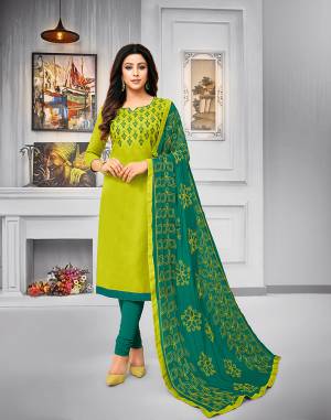 Add This Pretty Dress Material To Your Wardrobe In Parrot Green Colored Top Paired With Teal Green Colored Bottom And Dupatta. This Dress Material Is Cotton Based Paired With Chiffon Fabricated Dupatta. Its Top and Dupatta are Beautified With Attractive Resham Embroidery. 