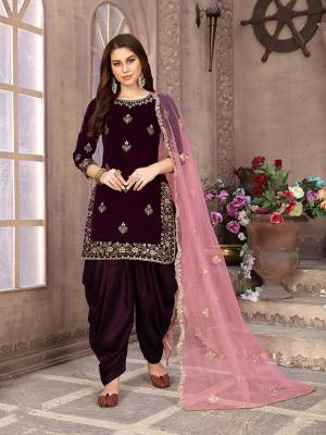 Grab This Beautiful Designer Patiala Suit In Wine Color Paired With Contrasting Pink Colored Dupatta. Its Embroidered Top Is Fabricated on Velvet Paired Santoon Bottom And Net Fabricated Dupatta. Buy Now.