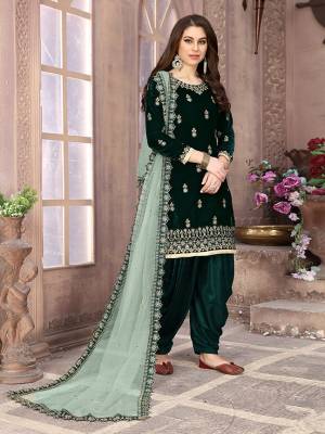 Grab This Beautiful Designer Patiala Suit In Pine Green Color Paired With Pastel Green Colored Dupatta. Its Embroidered Top Is Fabricated on Velvet Paired Santoon Bottom And Net Fabricated Dupatta. Buy Now.