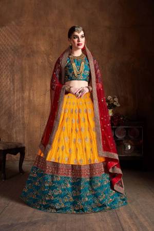 Go Colorful With This Heavy designer Lehenga choli In Teal Blue Colored Blouse Paired With Contrasting Musturd Yellow Colored lehenga And Red Colored Dupatta. Its Blouse IS Fabricated on Tafeta Art Silk Paired With Banarasi Art Silk Lehenga And Net Fabricated Dupatta. 