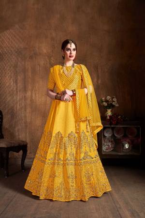 You Will Definitely Earn Lots Of Compliments Wearing This Heavy Designer Lehenga Choli In Yellow Color. This Pretty Designer Embroidered Lehenga Choli Is Fabricated On Art Silk Paired With Net Fabricated Dupatta. Buy This Lehenga Choli Now.