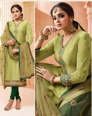 Go With The Lovely Shades Of Green With This Very Beautiful Designer Suit Which Comes With Two Bottoms In Dark Green And Light Green Colors. Its Top IS Fabricated On Satin Georgette Paired With Santoon Bottom, Georgette Fabricated Lehenga And Net Dupatta. 