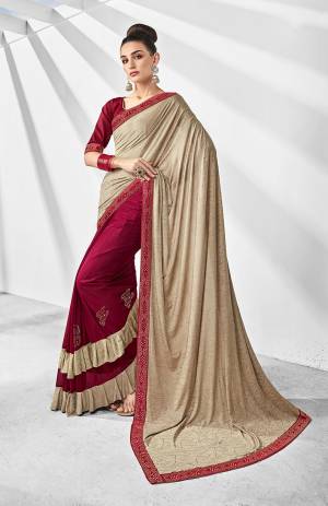 Here Is A Trending Frill Pattern Designer Saree In Cream And Dark Pink Paired With Dark Pink Colored Blouse. This Saree Is Fabricated On Lycra Paired With Art Silk Fabricated Blouse. It Is Beautified With Frill And Stone Work. 