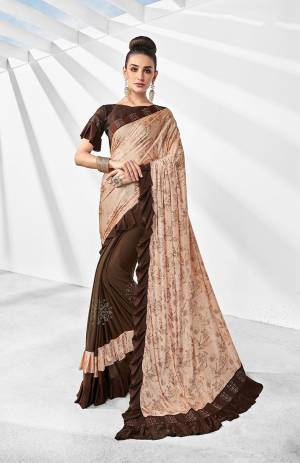 Here Is A Trending Frill Pattern Designer Saree In Peach And Brown Paired With Brown Colored Blouse. This Saree Is Fabricated On Lycra Paired With Art Silk Fabricated Blouse. It Is Beautified With Frill And Stone Work. 