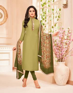 Lovely Shades In Green Are Here With This Designer Dress Material In Olive Green color paired With Dark Green Colored Bottom And Green And Multi Dupatta. It Hand Embroidered Top Is Silk Based Paired With Paired With Santoon Bottom And Chinon Fabricated Digital Printed Dupatta. 